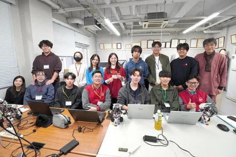 Students and instructors in Gunma University's robotics lab