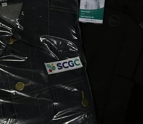 Ratchanon wearing an SCGC jacket and staff badge